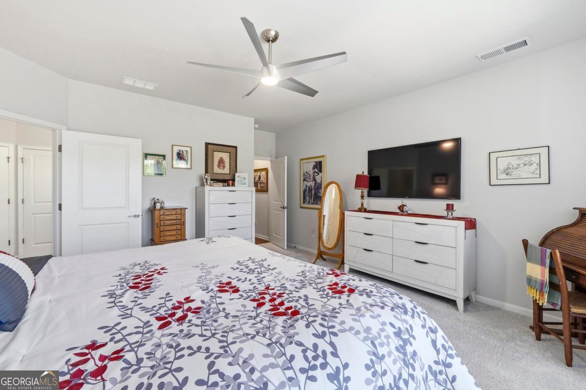1101 Little Shls Road Greensboro, GA 30642 - Photo 22 of 42 a bed room with a bed and a flat screen tv
