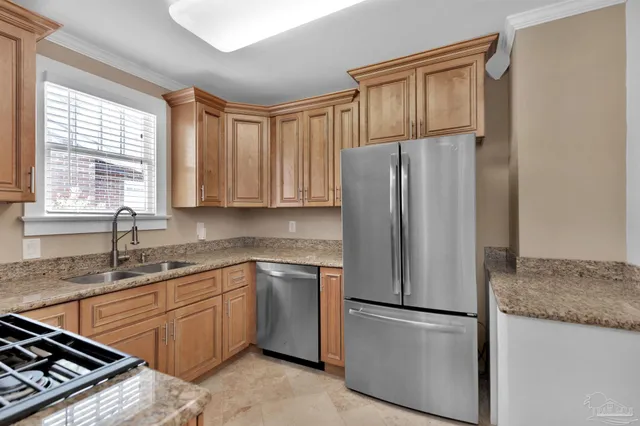 a kitchen with stainless steel appliances granite countertop a refrigerator sink and cabinets