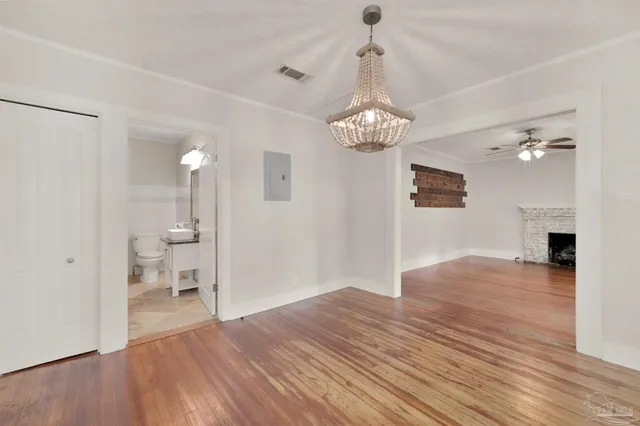 a view of livingroom with chandelier and wooden floor