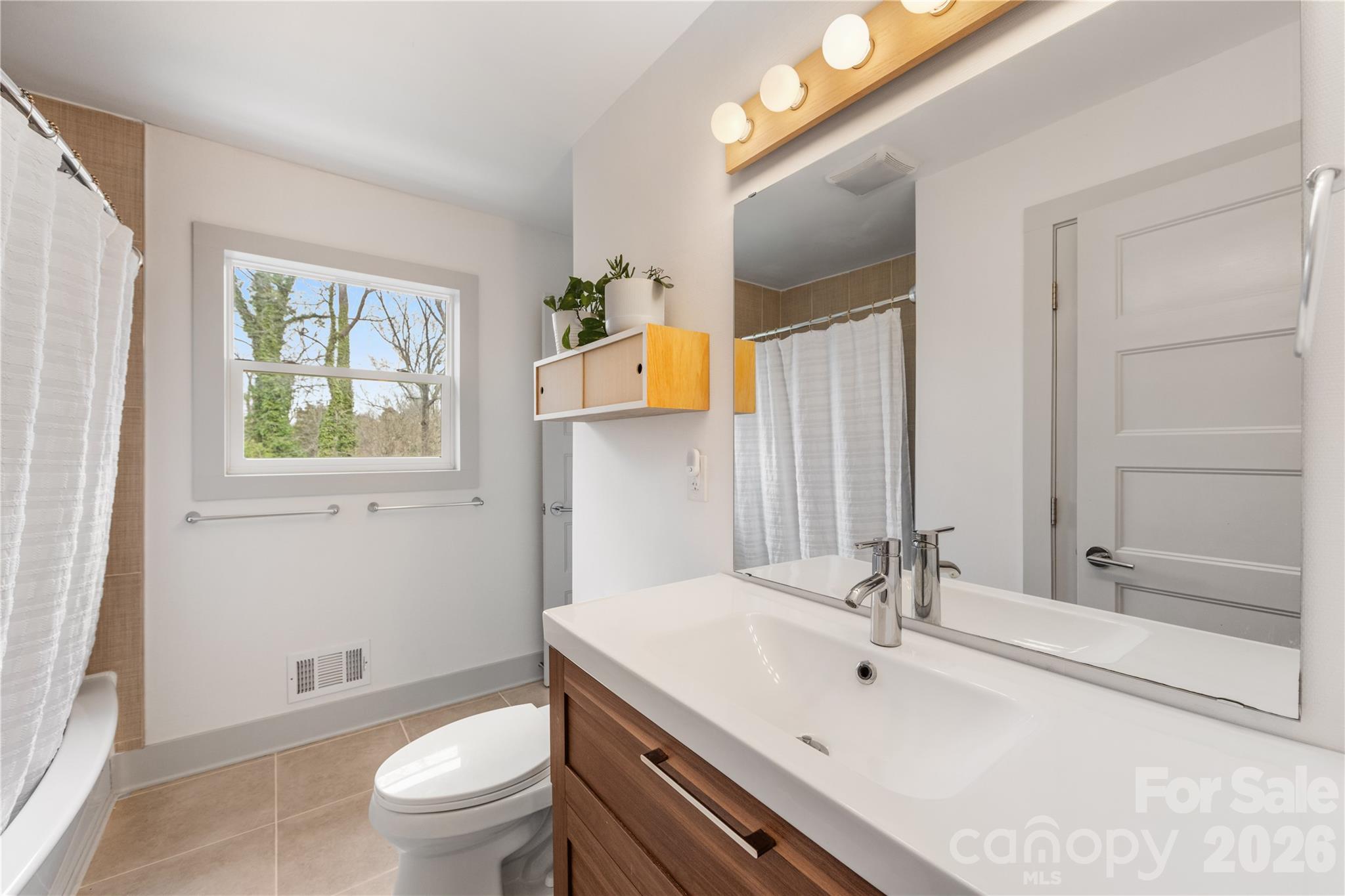 6229 Springfield Drive Charlotte, NC 28212 - Photo 12 of 44 a bathroom with a sink a toilet and shower