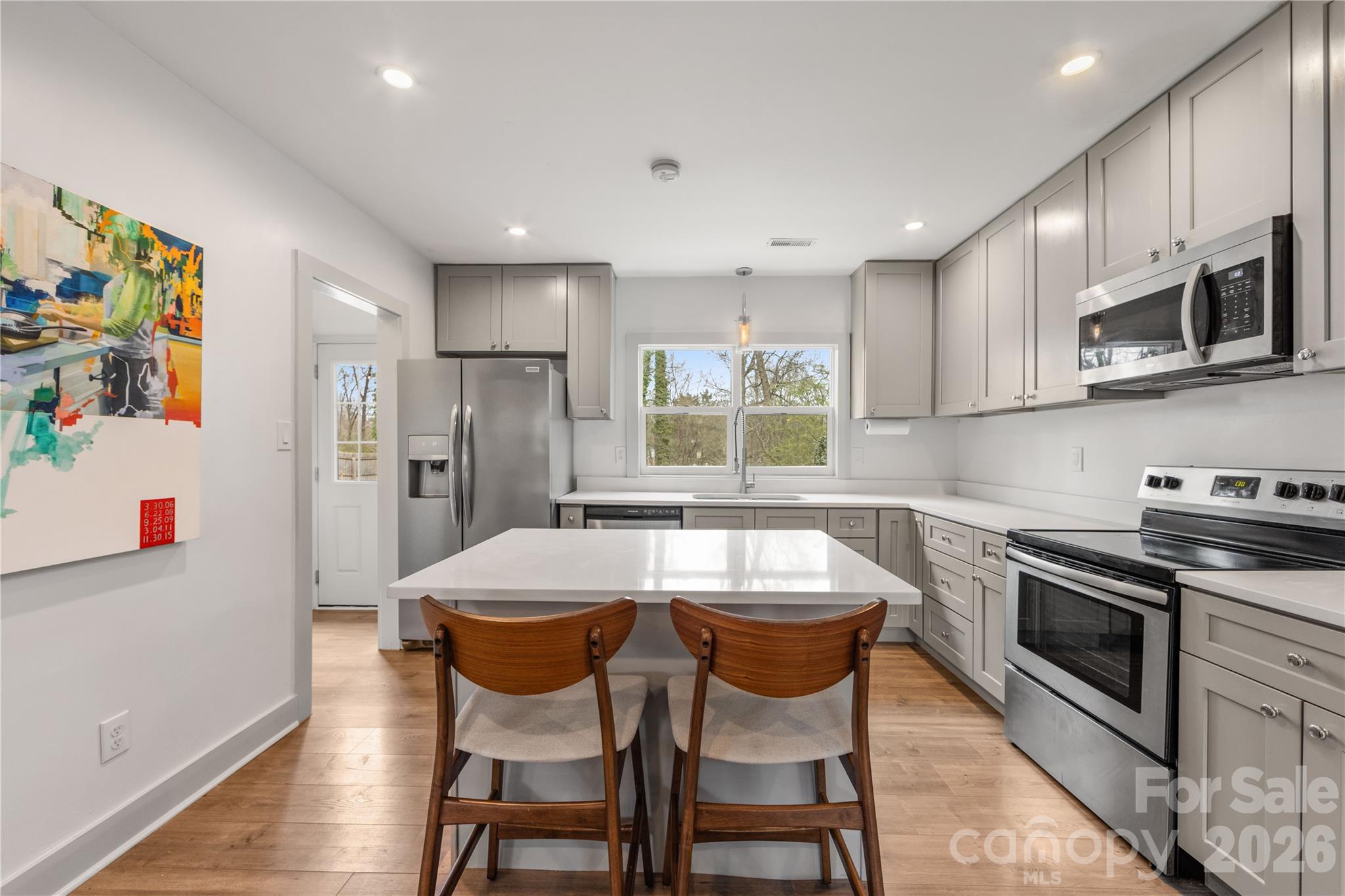 6229 Springfield Drive Charlotte, NC 28212 - Photo 27 of 44 a kitchen with stainless steel appliances granite countertop a stove a sink a microwave a refrigerator and cabinets