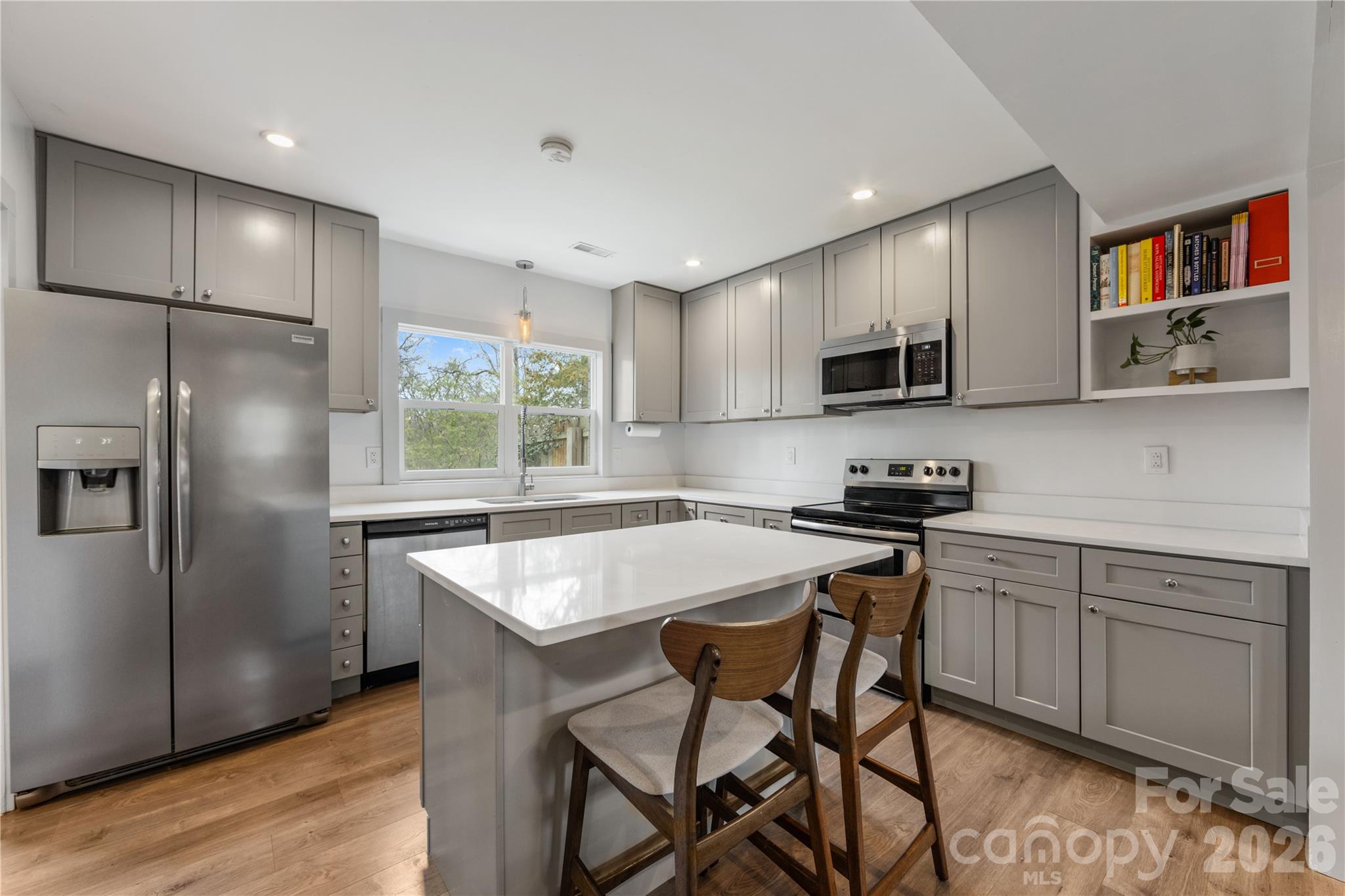 6229 Springfield Drive Charlotte, NC 28212 - Photo 28 of 44 a kitchen with stainless steel appliances granite countertop a table chairs sink refrigerator and microwave