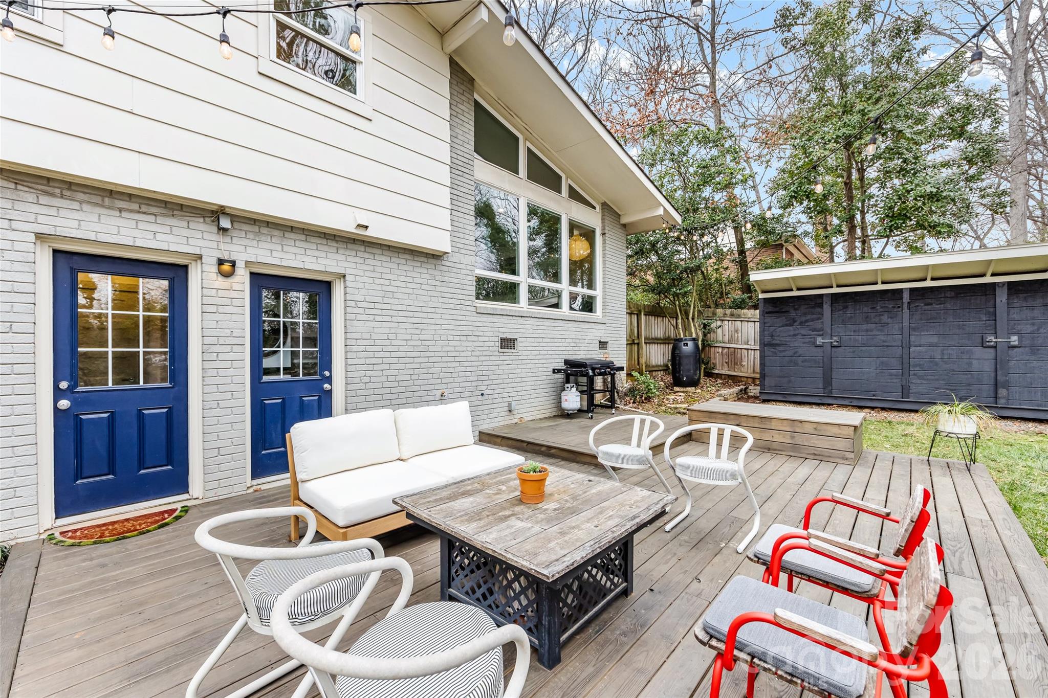 6229 Springfield Drive Charlotte, NC 28212 - Photo 35 of 44 a view of a patio with couches table and chairs and wooden floor