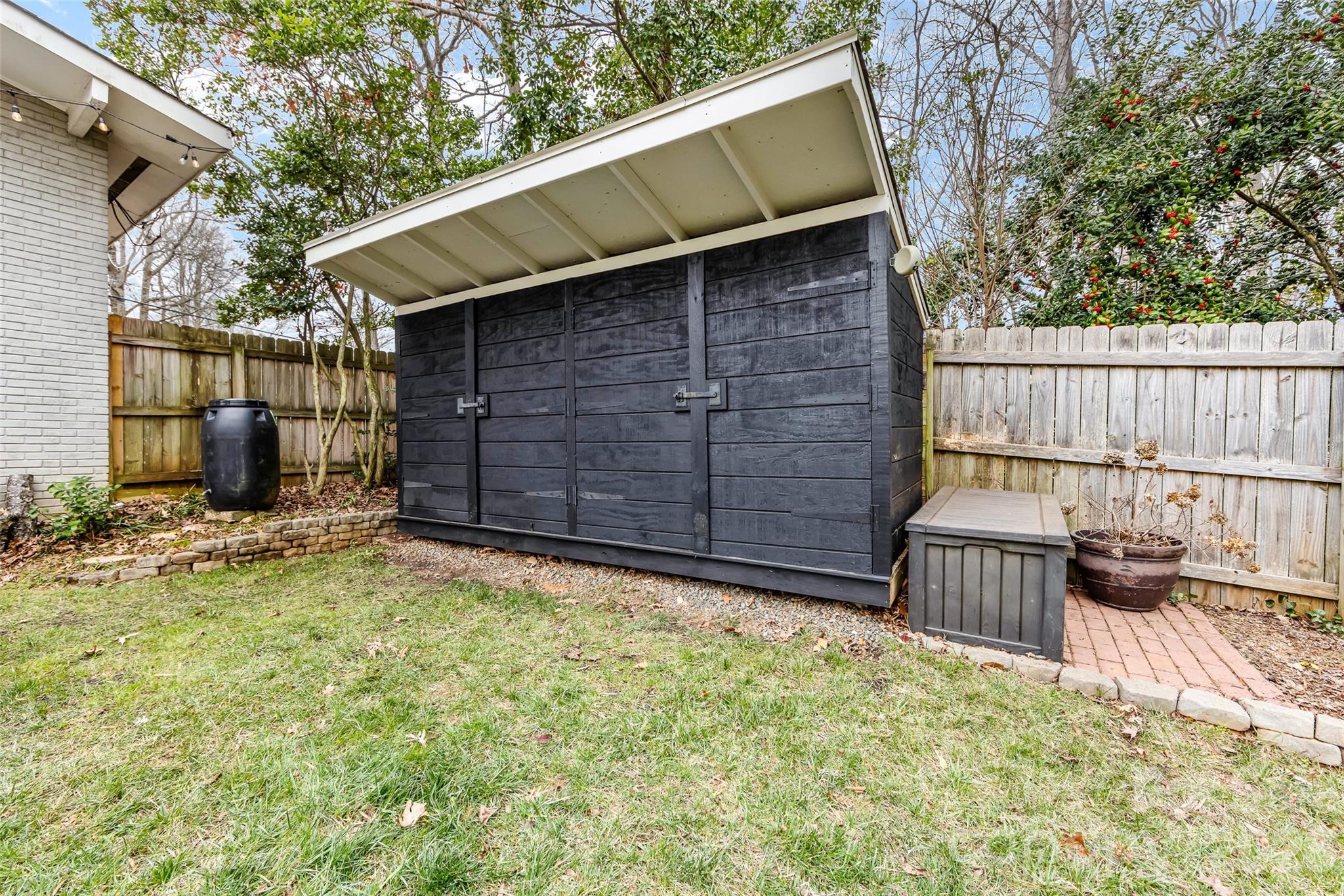 6229 Springfield Drive Charlotte, NC 28212 - Photo 38 of 44 a backyard of a house with a large tree and wooden fence