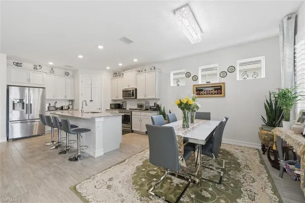 a large kitchen with stainless steel appliances granite countertop a sink a stove and a refrigerator