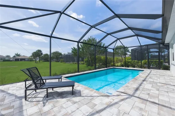 a view of a swimming pool with a yard