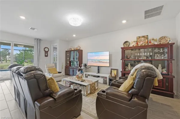 a living room with furniture a large window and a fireplace