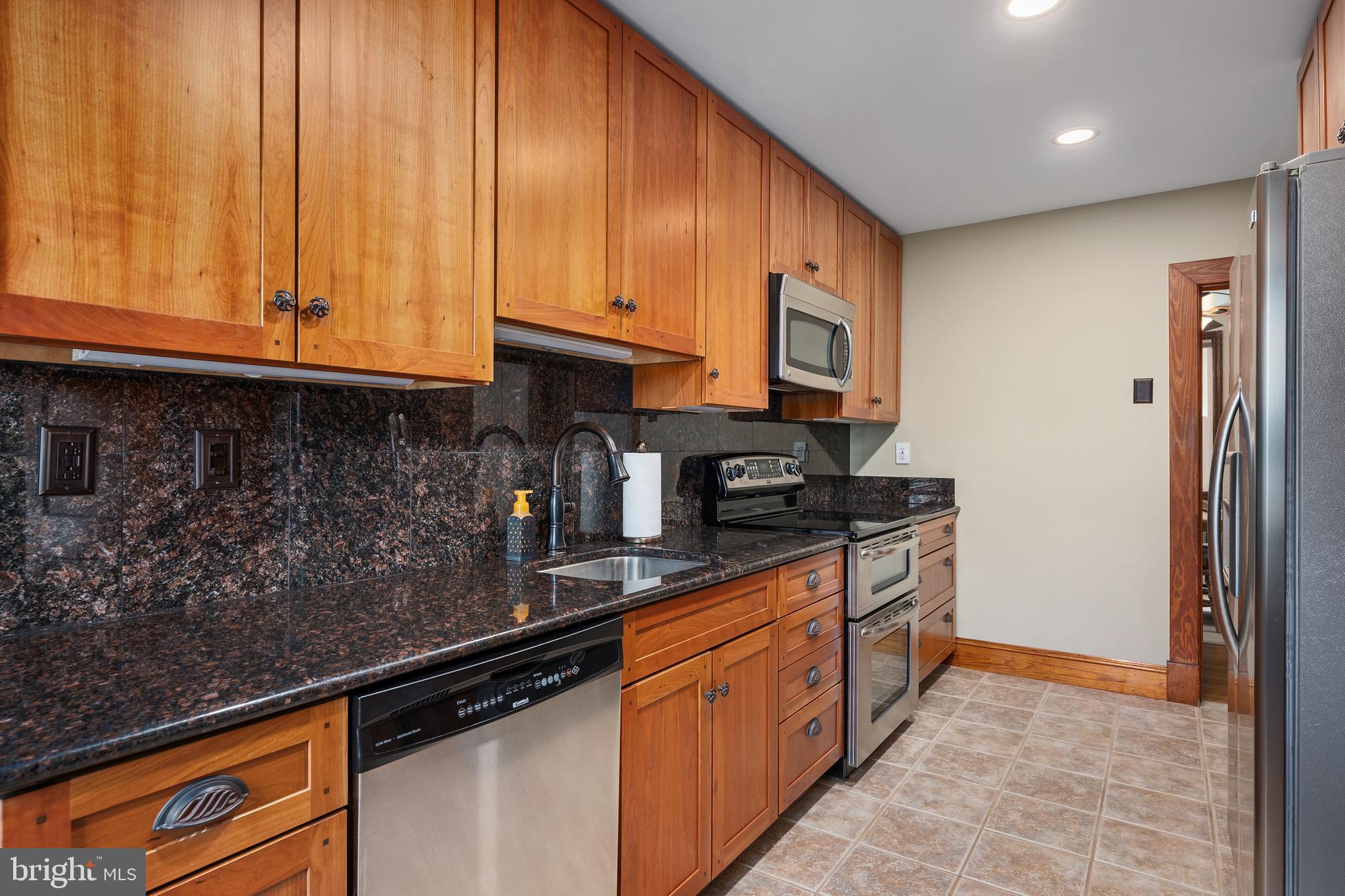 758 North Houcksville Road Hampstead, MD 21074 - Photo 11 of 43 a kitchen with stainless steel appliances granite countertop a stove a sink and a microwave