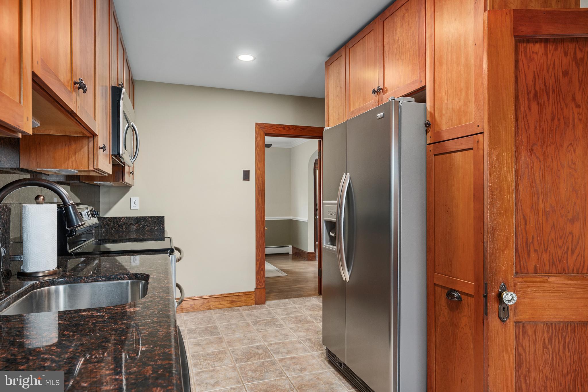 758 North Houcksville Road Hampstead, MD 21074 - Photo 12 of 43 a kitchen with stainless steel appliances granite countertop a refrigerator and a sink
