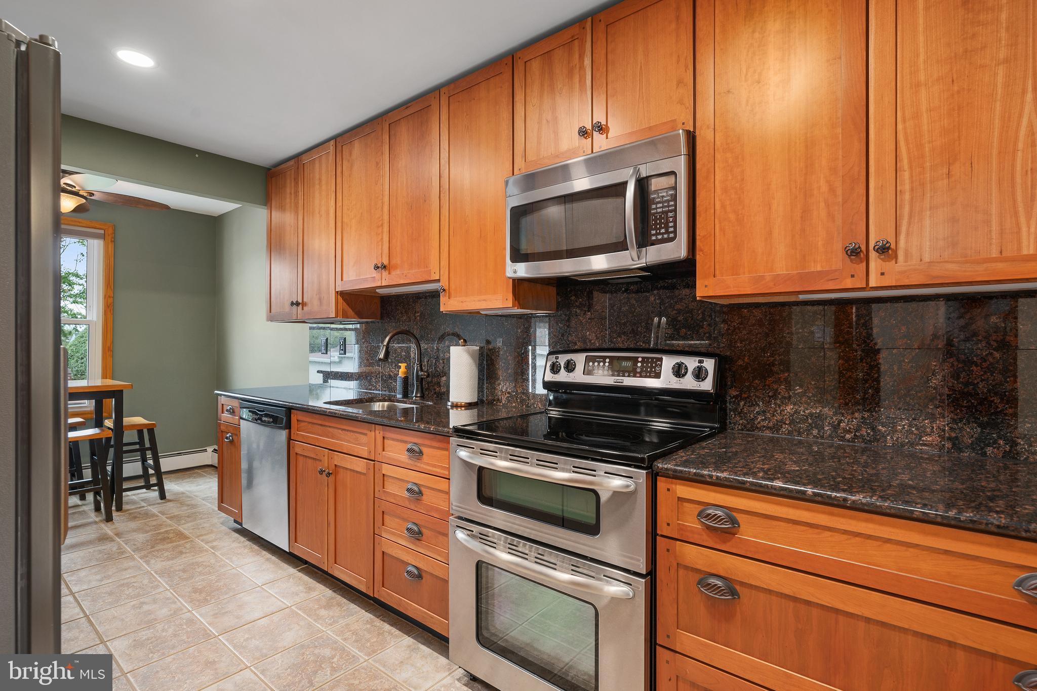 758 North Houcksville Road Hampstead, MD 21074 - Photo 13 of 43 a kitchen with stainless steel appliances granite countertop a stove a sink and a microwave