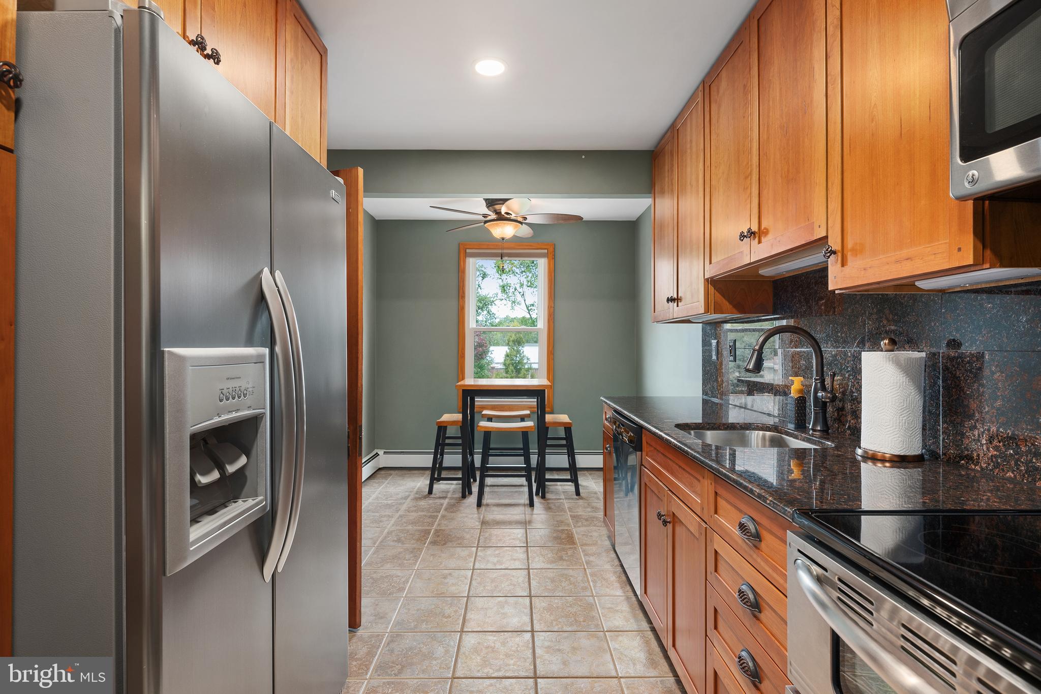 758 North Houcksville Road Hampstead, MD 21074 - Photo 14 of 43 a kitchen with stainless steel appliances granite countertop a sink and a refrigerator