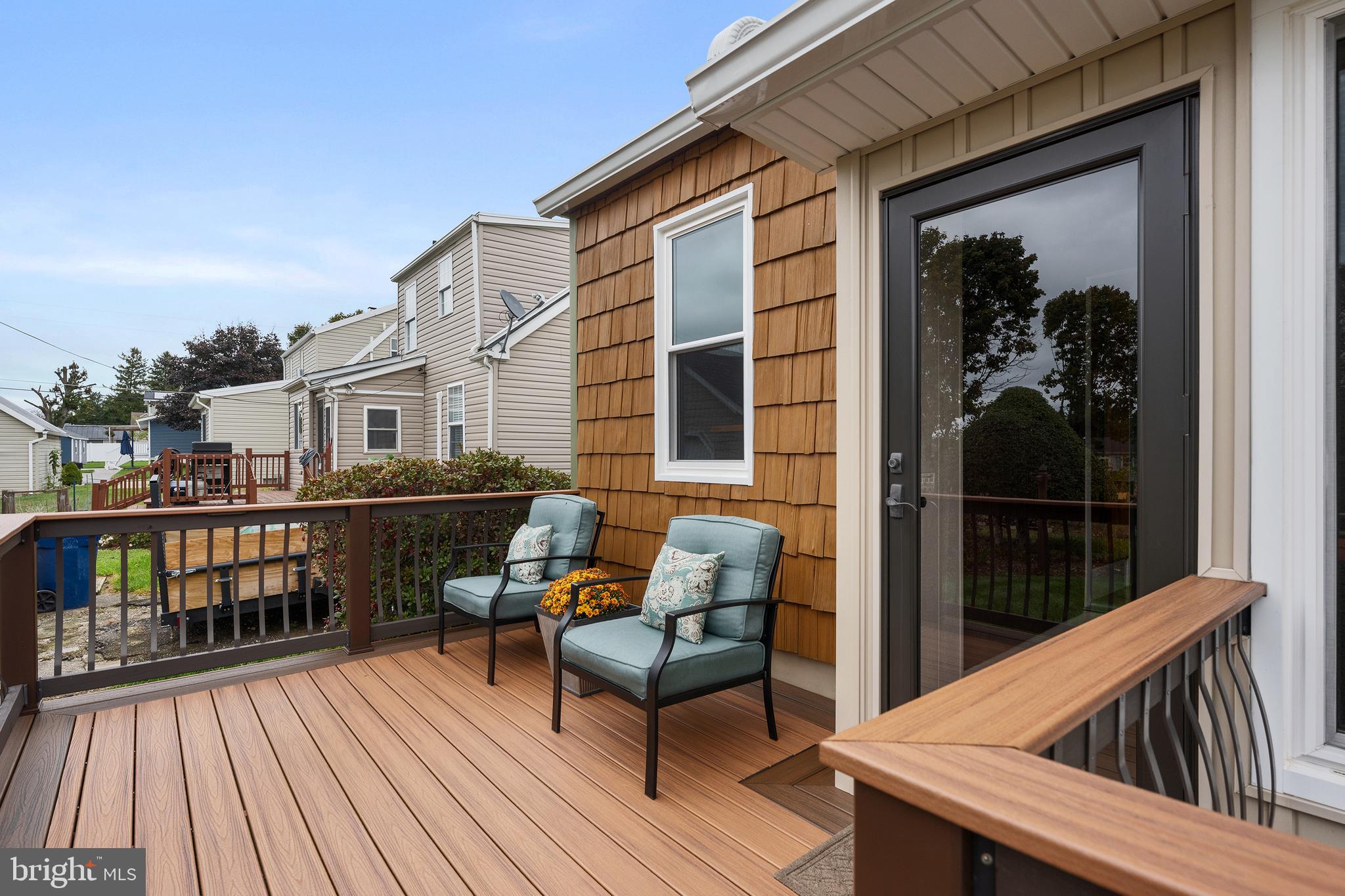 758 North Houcksville Road Hampstead, MD 21074 - Photo 19 of 43 a view of a balcony with two chairs and wooden floor