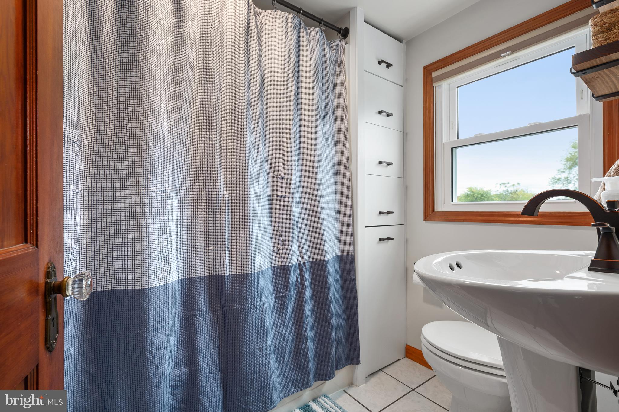 758 North Houcksville Road Hampstead, MD 21074 - Photo 25 of 43 a bathroom with a toilet a sink and a window