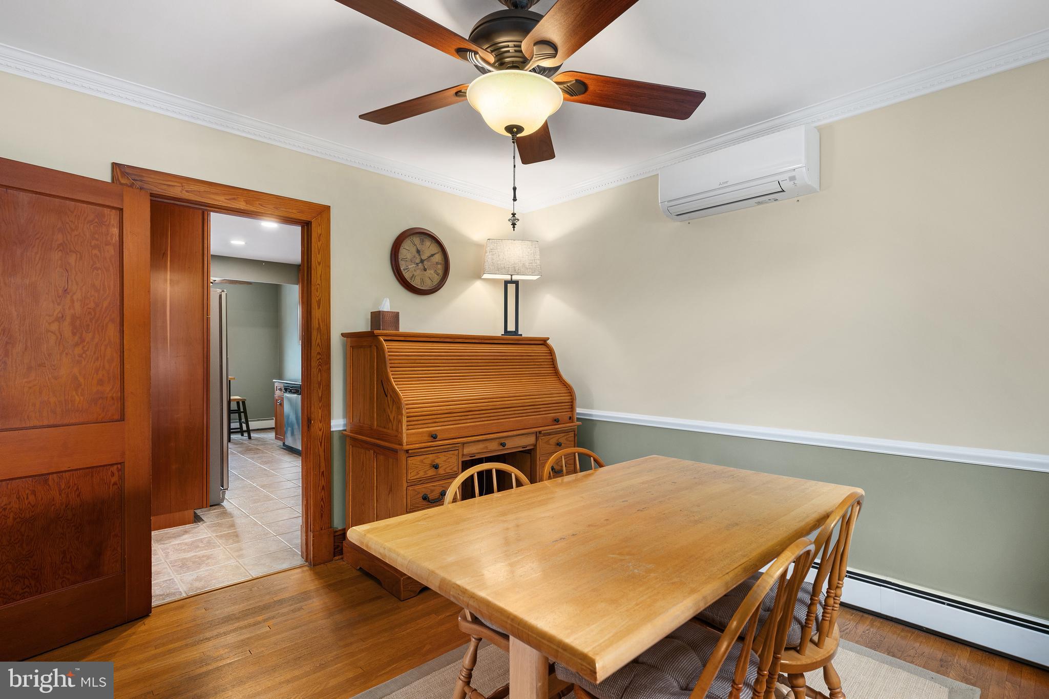 758 North Houcksville Road Hampstead, MD 21074 - Photo 10 of 43 a living room with a table chairs and wooden floor
