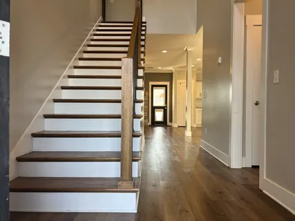 a view of entryway and hall with wooden floor