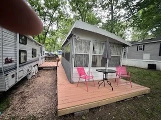 a living room with stainless steel appliances furniture a couch and a kitchen view