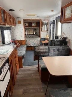 a kitchen with wooden cabinets and a stove top oven