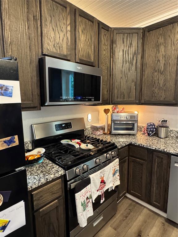 2300 Lyle Avenue Waco, TX 76708 - Photo 13 of 23 a kitchen with stainless steel appliances granite countertop a stove a sink and a microwave