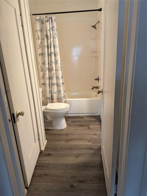 2300 Lyle Avenue Waco, TX 76708 - Photo 16 of 23 a bathroom with a sink a toilet a window and a shower