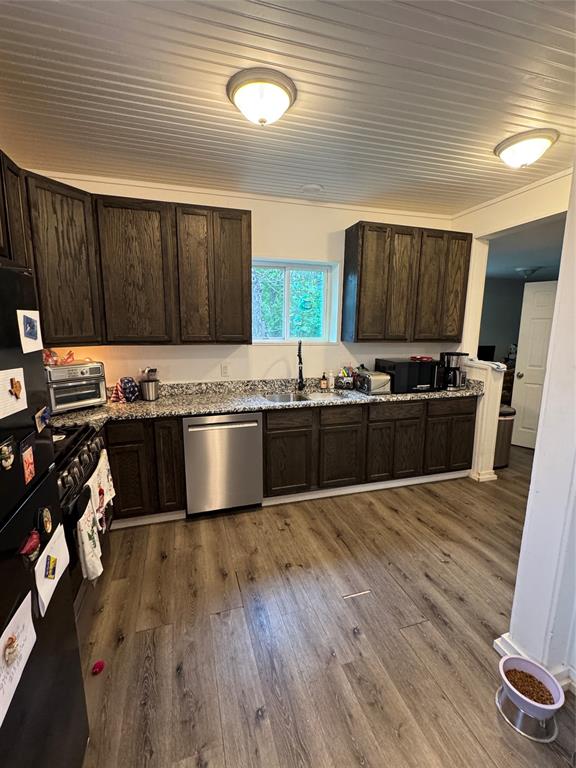 2300 Lyle Avenue Waco, TX 76708 - Photo 9 of 23 a kitchen with stainless steel appliances granite countertop a stove a sink dishwasher and a microwave oven with cabinets