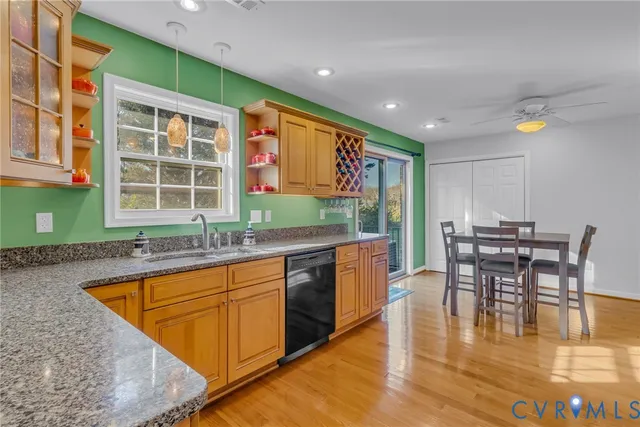 a kitchen with stainless steel appliances granite countertop a stove and a dining table chair