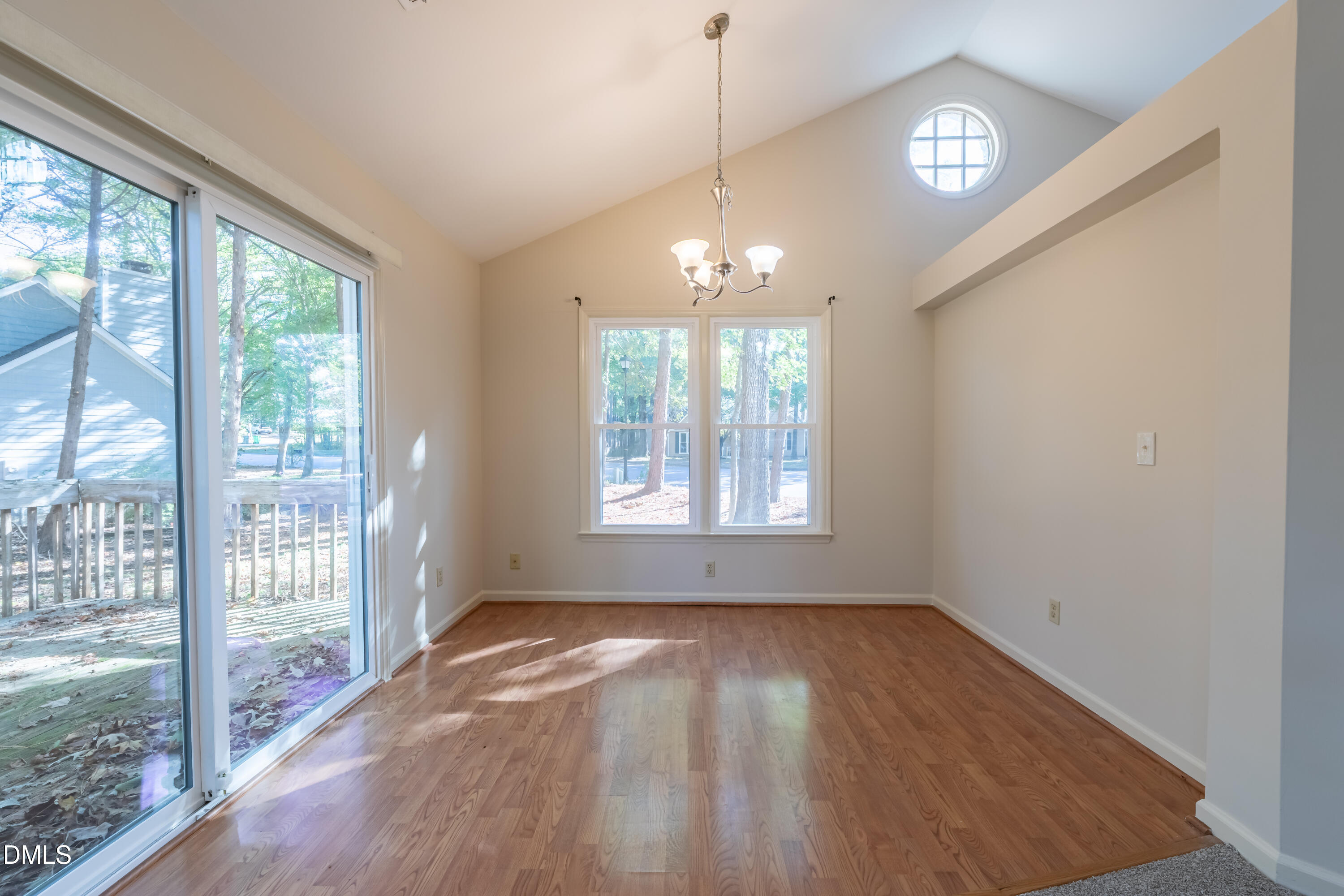 3609 Singleleaf Lane Raleigh, NC 27616 - Photo 12 of 41 an empty room with wooden floor and windows