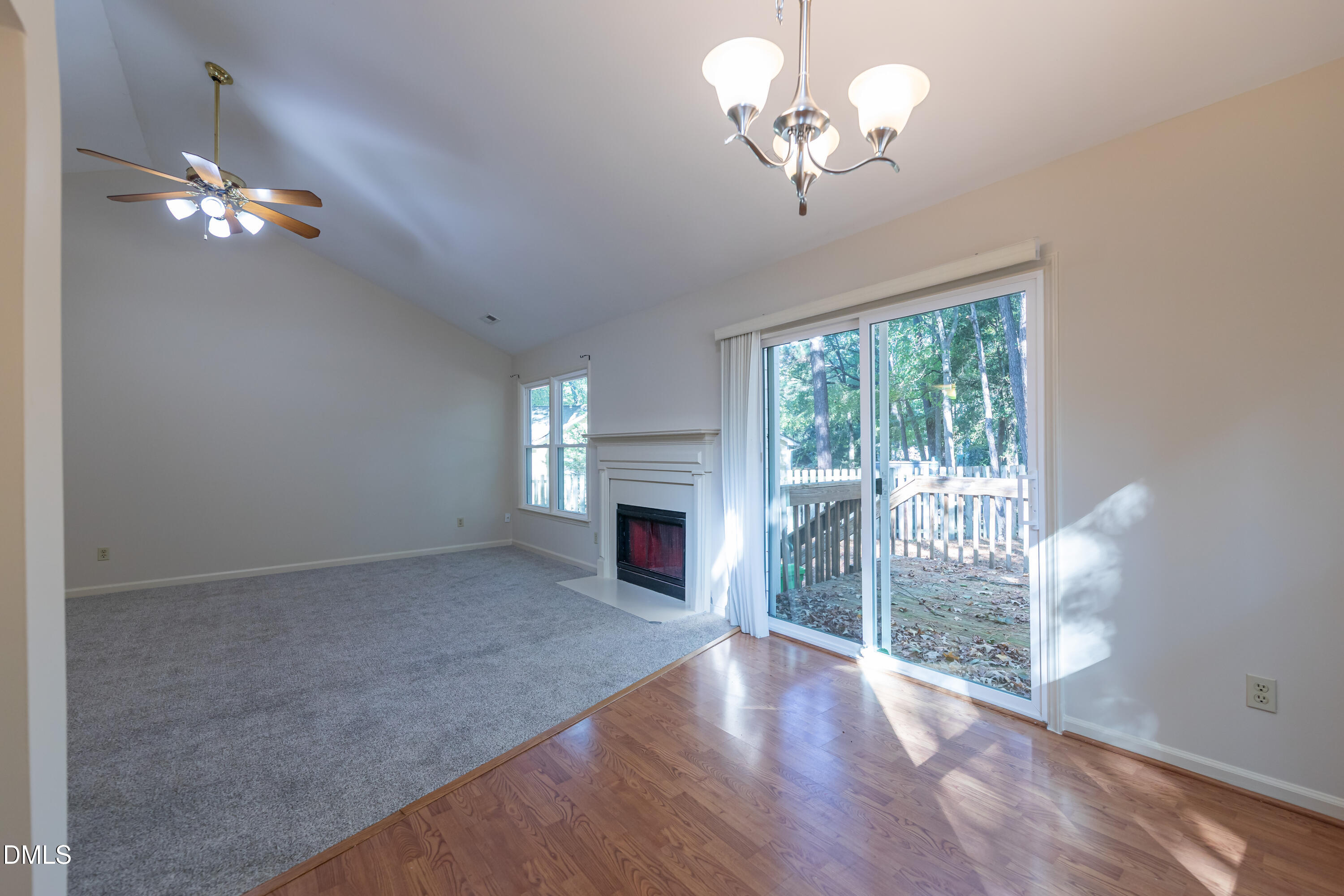 3609 Singleleaf Lane Raleigh, NC 27616 - Photo 13 of 41 a view of a livingroom with a fireplace a chandelier fan and wooden floor