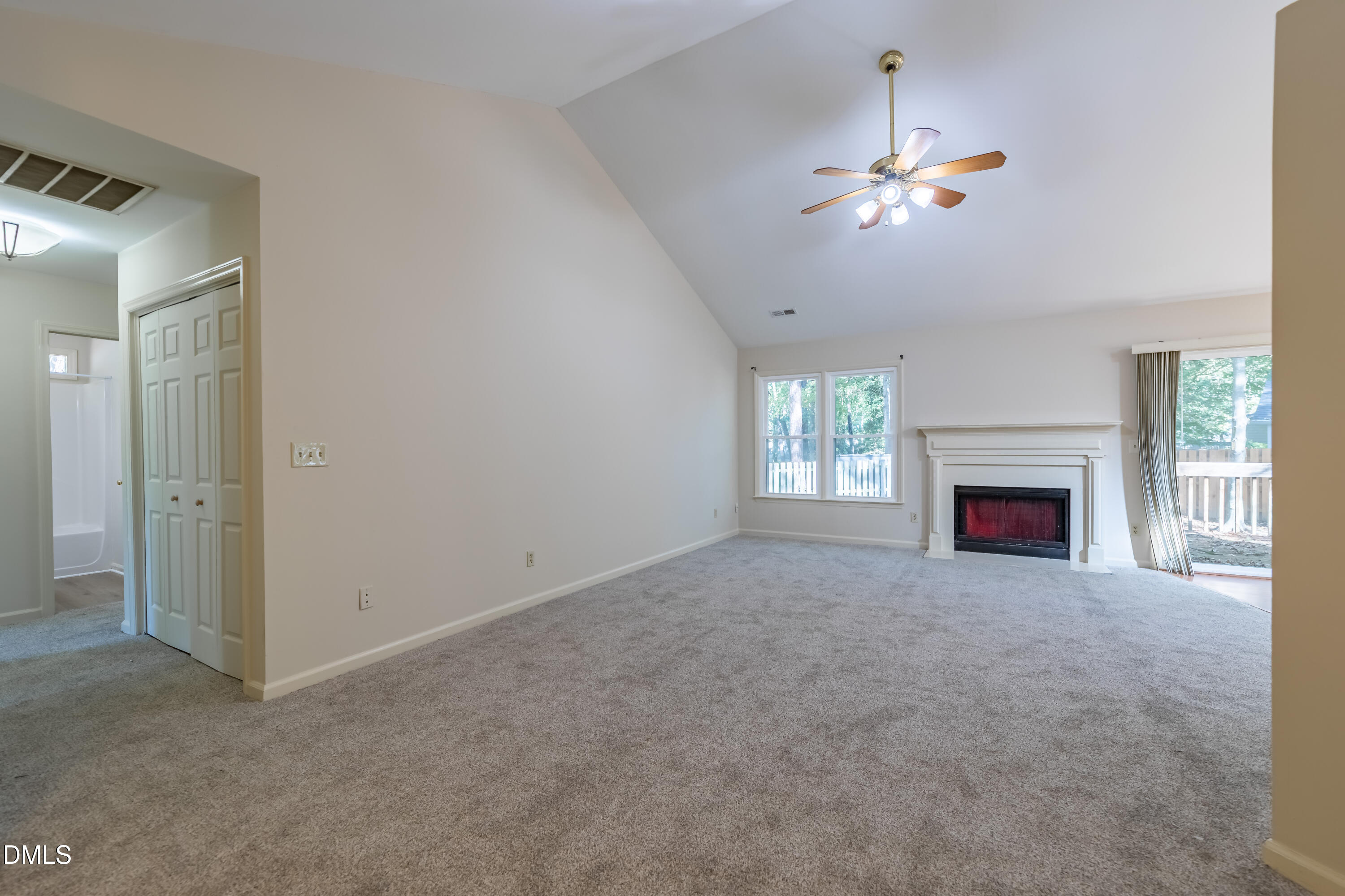 3609 Singleleaf Lane Raleigh, NC 27616 - Photo 5 of 41 a view of a livingroom with a fireplace a chandelier and windows