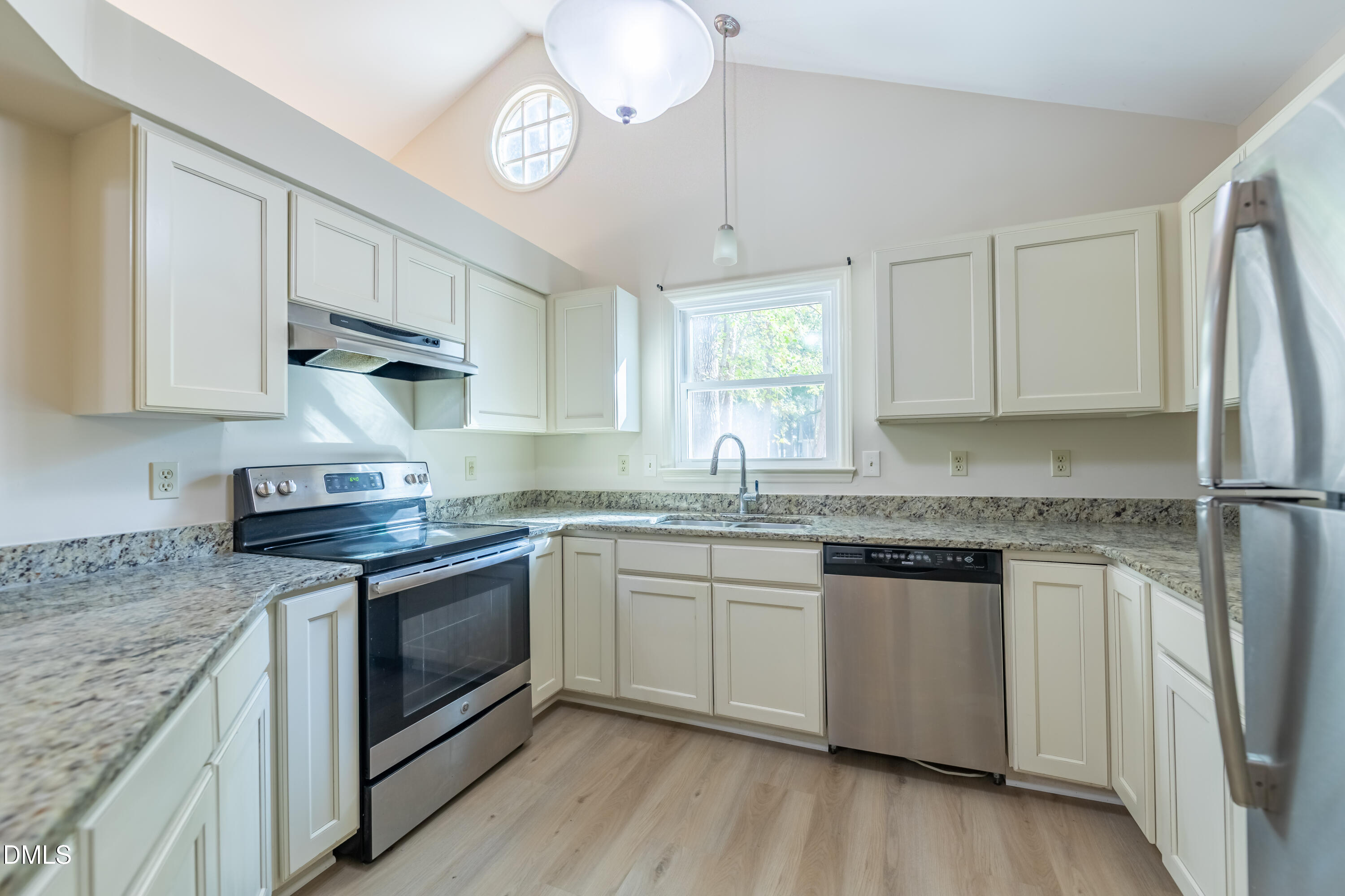 3609 Singleleaf Lane Raleigh, NC 27616 - Photo 9 of 41 a kitchen with stainless steel appliances granite countertop a sink stove and refrigerator