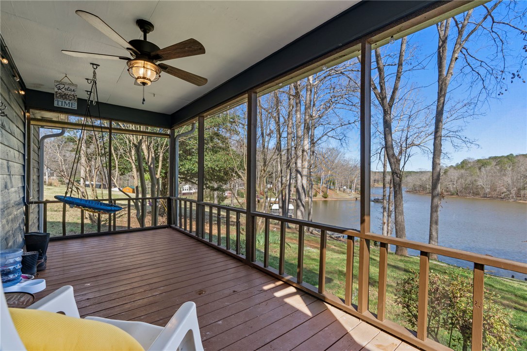 122 Latham Drive Anderson, SC 29621 - Photo 5 of 40 This screened porch offers serene lake views, providing a peaceful escape for relaxation.