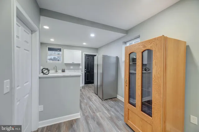 a view of kitchen with stainless steel appliances granite countertop a refrigerator and a sink