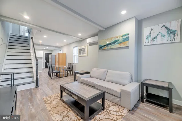 a living room with furniture and wooden floor