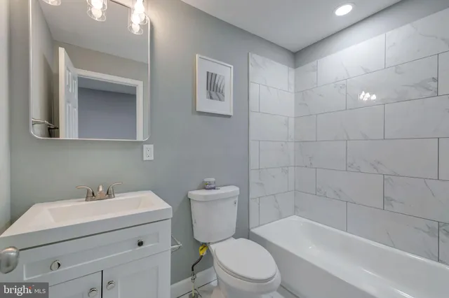 a bathroom with a sink a toilet and bathtub
