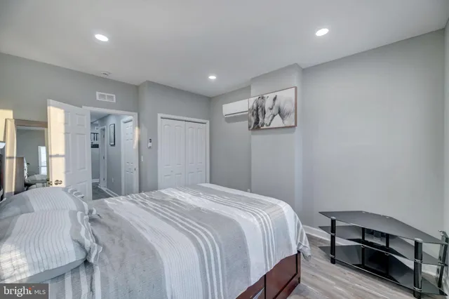 a spacious bedroom with a bed and a desk