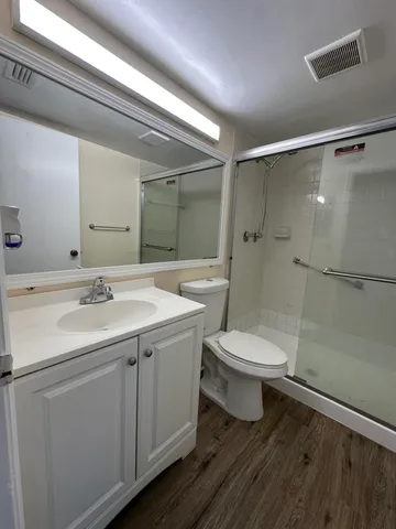 a bathroom with a toilet sink and shower