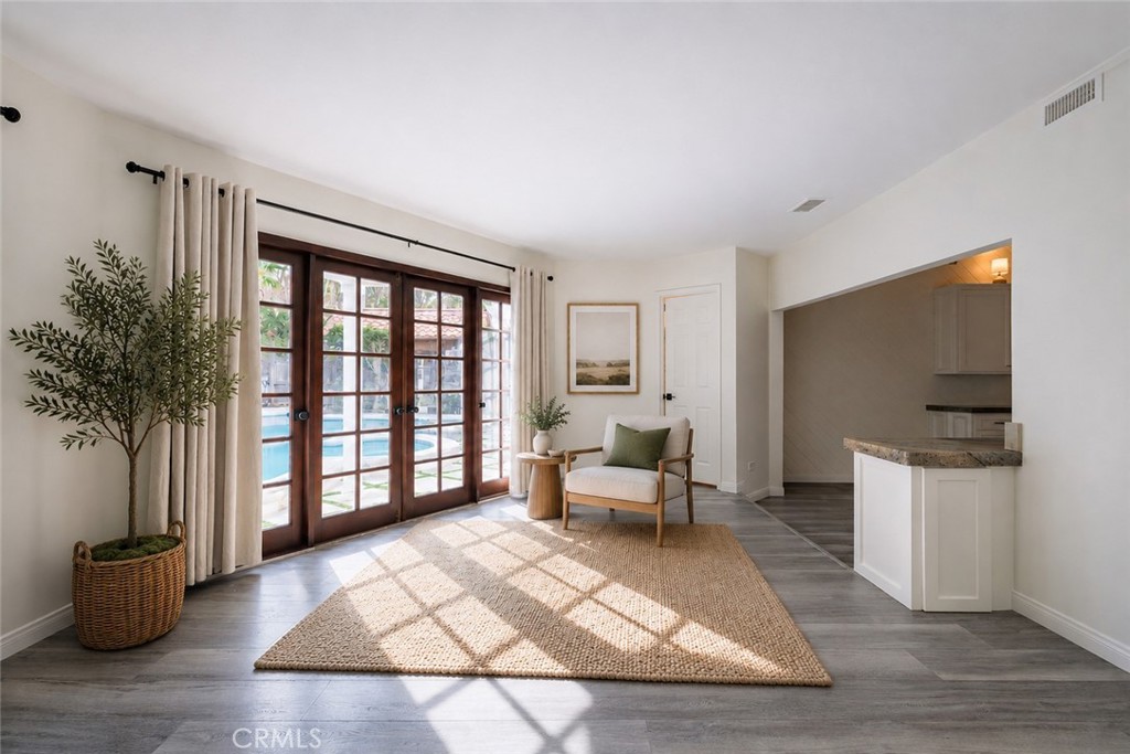 25342 Hugo Road Laguna Niguel, CA 92677 - Photo 14 of 36 Family Room with french doors looking out the pool - Virtualy Staged