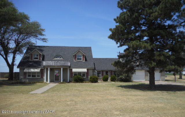 a front view of a house with a yard and a garage