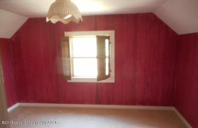233 Fm 378 Silverton, TX 79257 - Photo 6 of 9 an empty room with wooden floor and windows