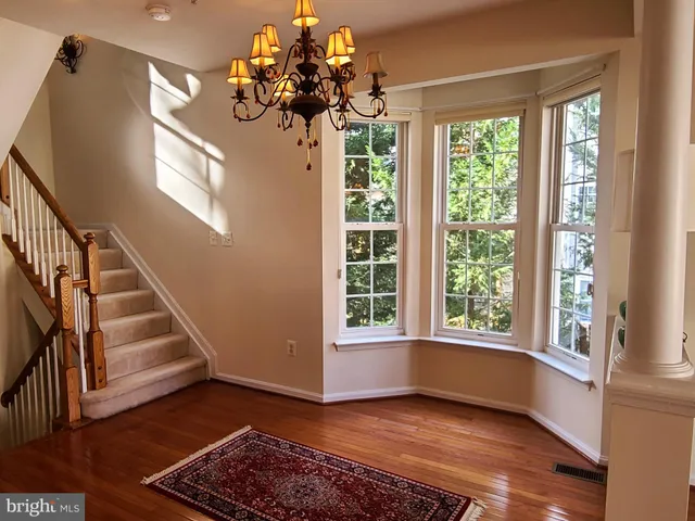 a view of an entryway with wooden floor and a chandelier