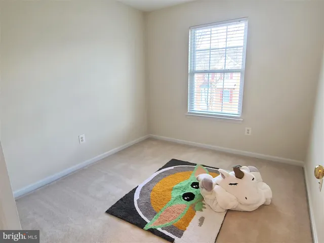 a view of a livingroom with furniture and a window