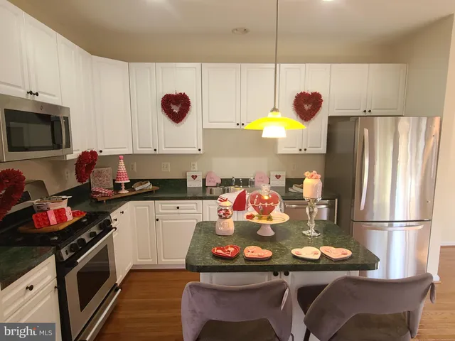 a kitchen with a sink appliances and cabinets