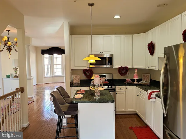 a kitchen with a sink appliances and cabinets