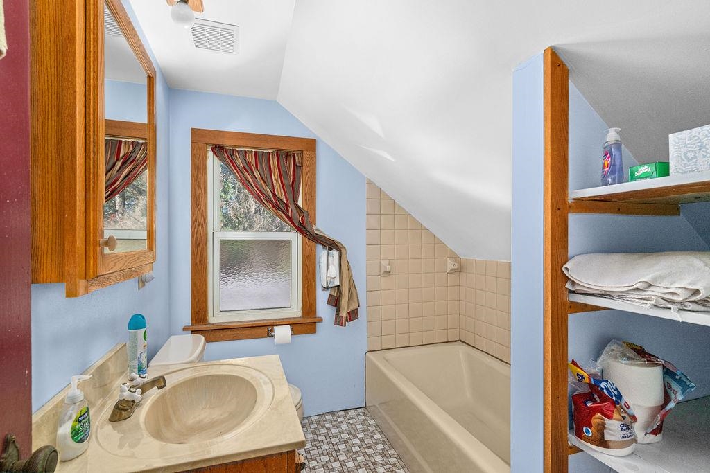 434 12th Street Cloquet, MN 55720 - Photo 15 of 22 Full bath featuring a garden tub, vaulted ceiling, and vanity