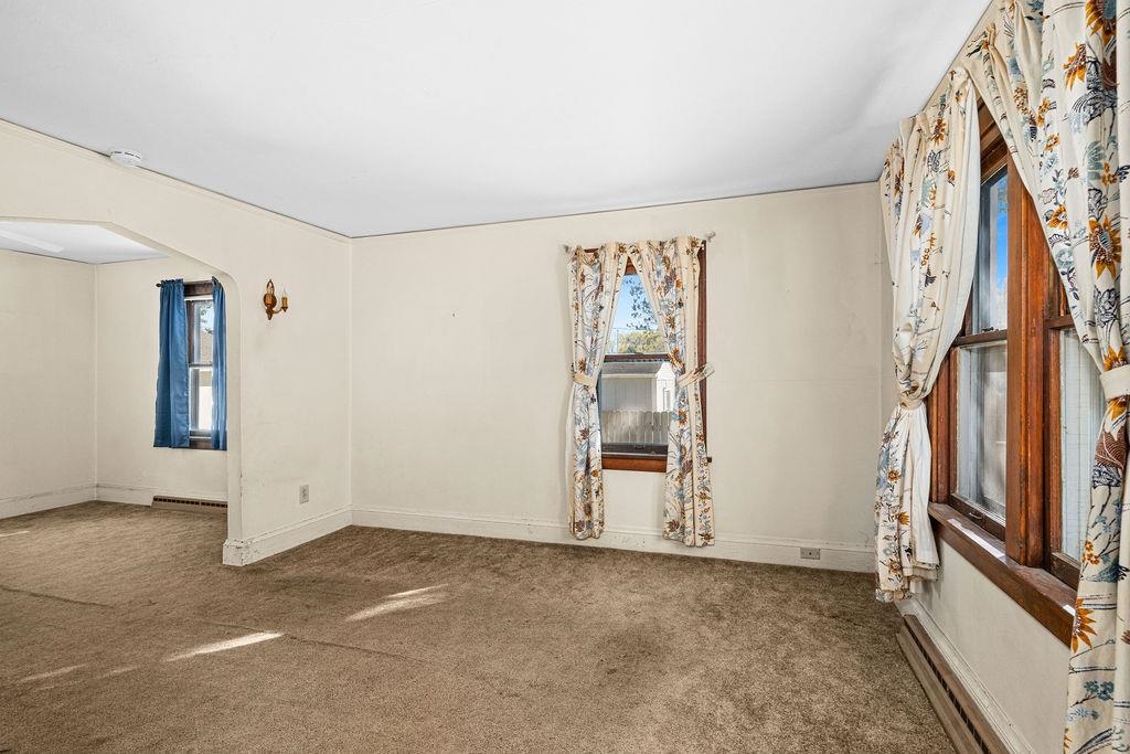 434 12th Street Cloquet, MN 55720 - Photo 2 of 22 Carpeted spare room with arched walkways and a baseboard heating unit