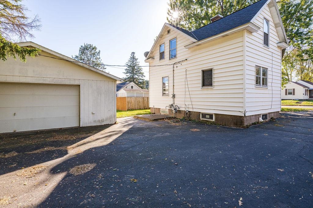 434 12th Street Cloquet, MN 55720 - Photo 21 of 22 Rear view of house with roof with shingles, a chimney, and an outdoor structure