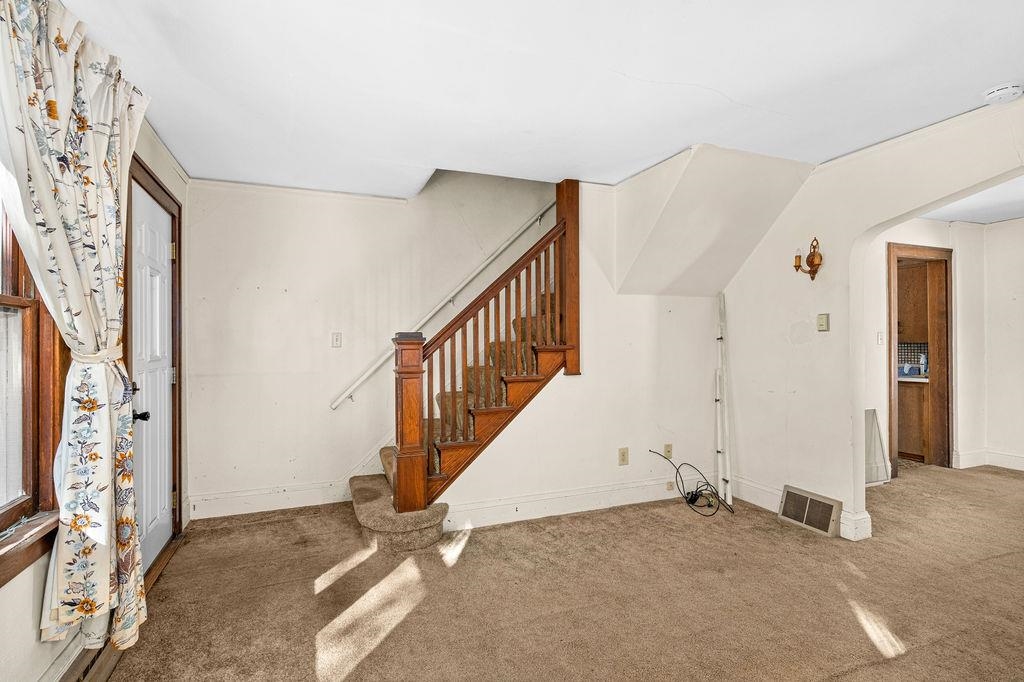 434 12th Street Cloquet, MN 55720 - Photo 3 of 22 Unfurnished living room with carpet floors and stairs