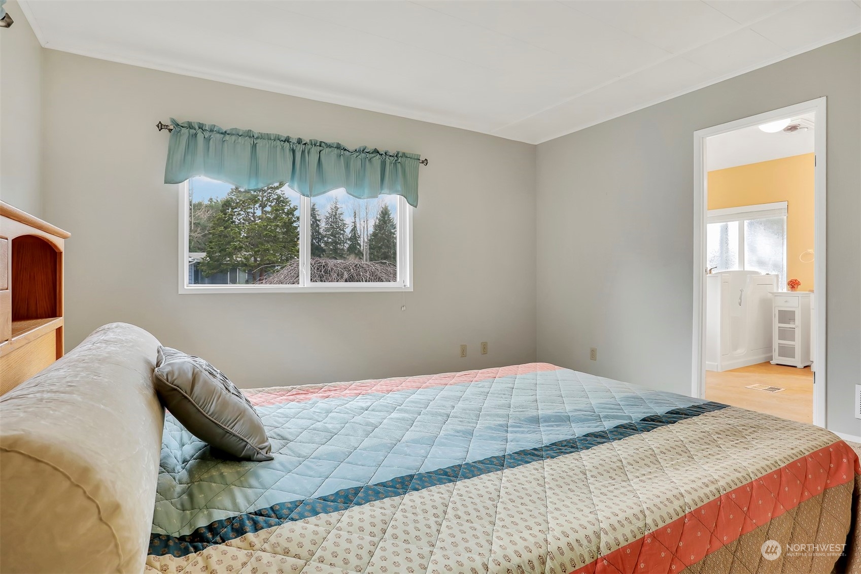 23921 Lake Drive West Bothell, WA 98021 - Photo 22 of 40 a bedroom with a bed and a painting on the wall