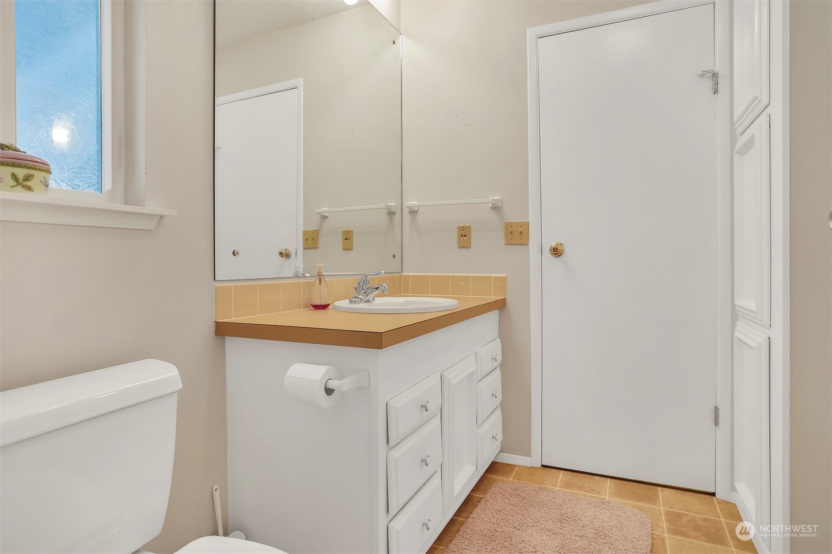23921 Lake Drive West Bothell, WA 98021 - Photo 27 of 40 a bathroom with a sink a toilet and a mirror