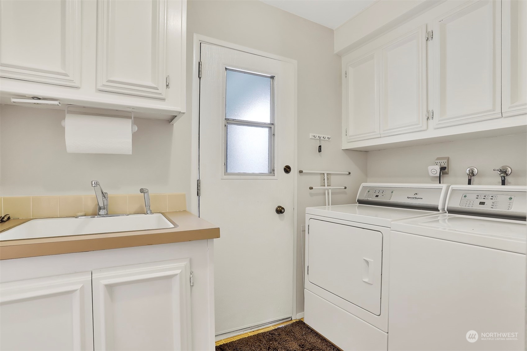 23921 Lake Drive West Bothell, WA 98021 - Photo 28 of 40 a kitchen with white cabinets and sink
