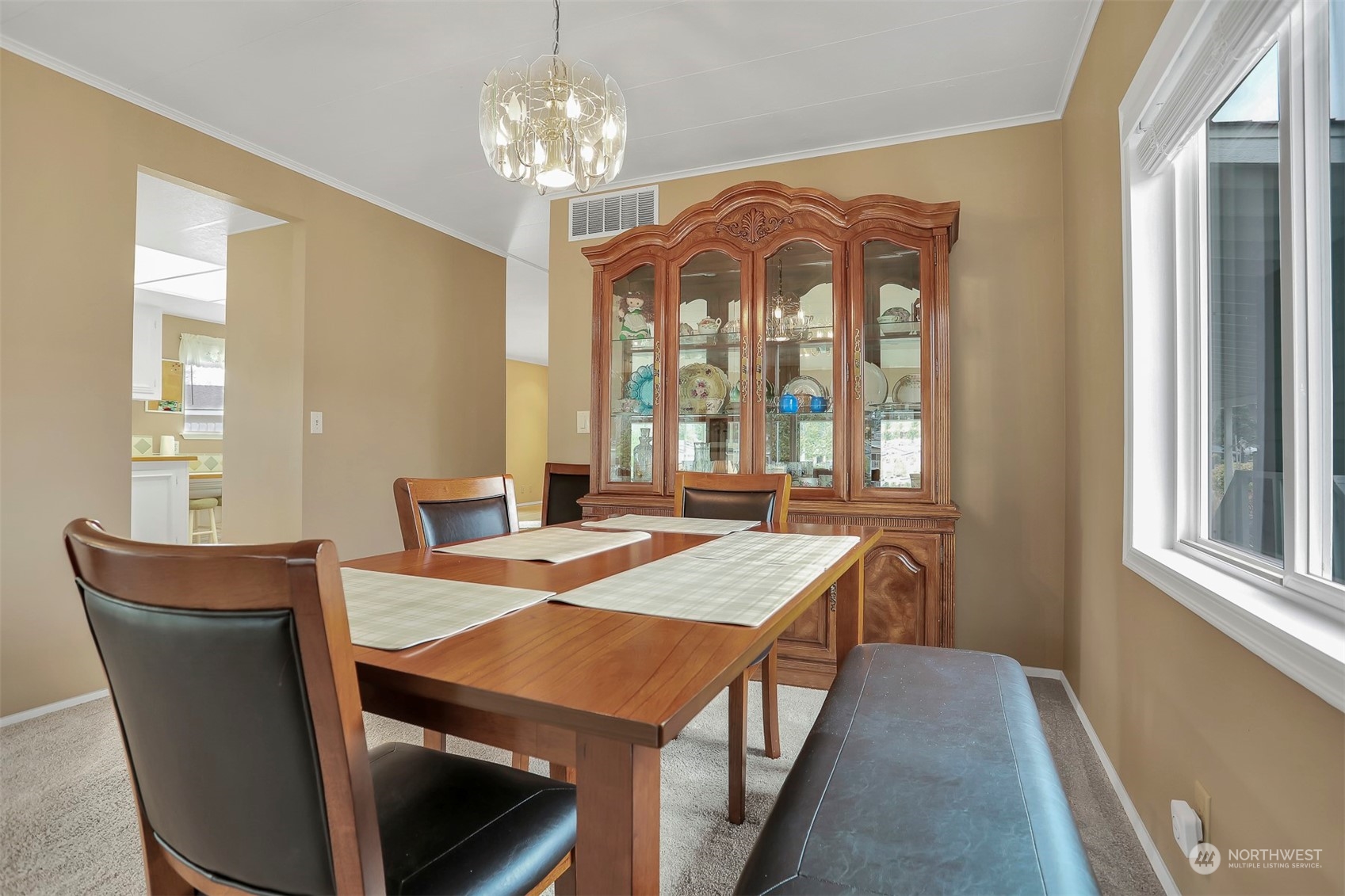 23921 Lake Drive West Bothell, WA 98021 - Photo 10 of 40 a dining room with wooden floor a chandelier a wooden table and chairs